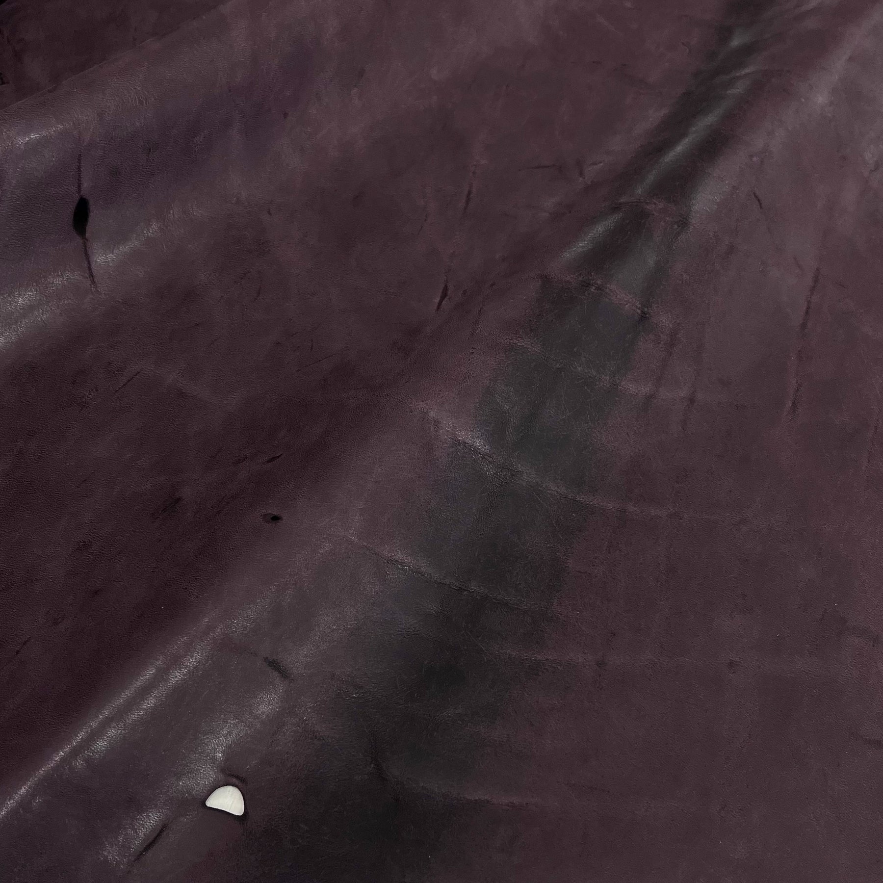 scarred horse leather in burgundy 