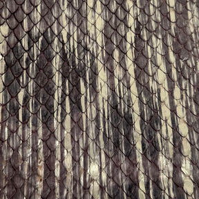 Exotic python leather in Gilded Plum with a soft metallic finish for bags and jackets.