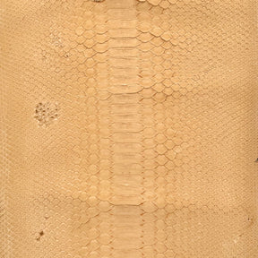 Nubuck Python leather hide in a soft dried peach color, perfect for luxury leather goods.